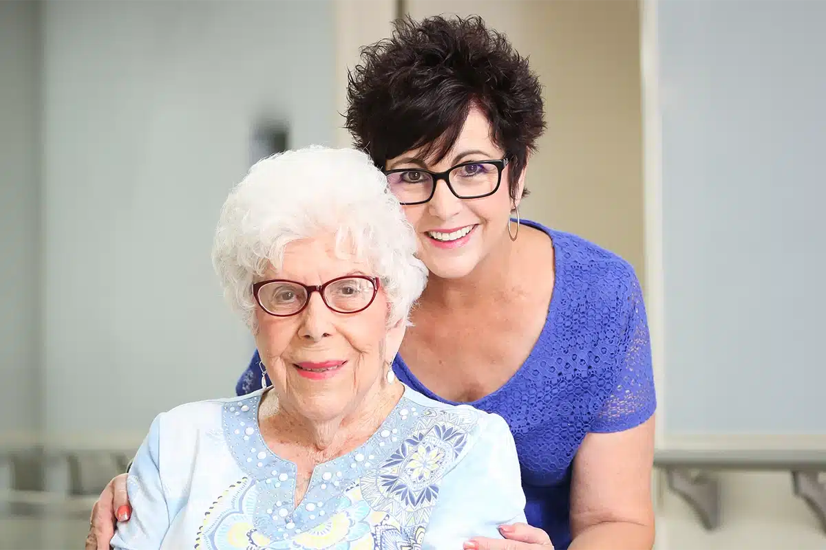 PACS-300x200-caregiver1 A caregiver and an older woman in a wheelchair at Hanford Post Acute